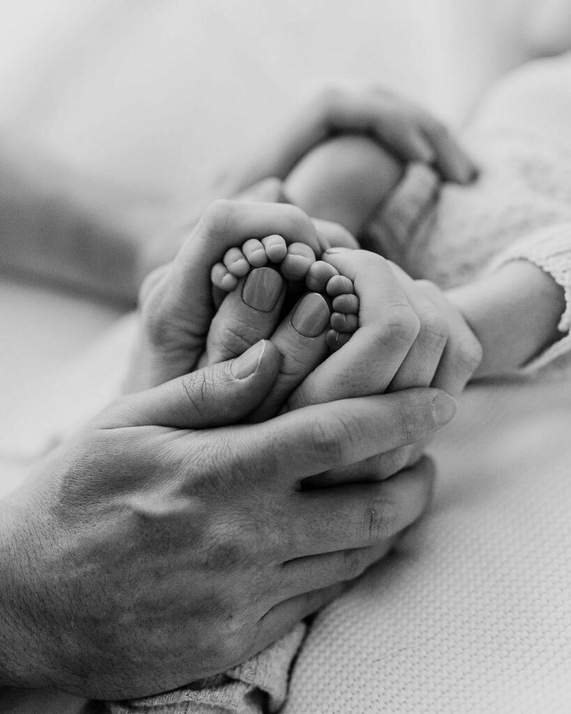 Baby feet in his parent's hand